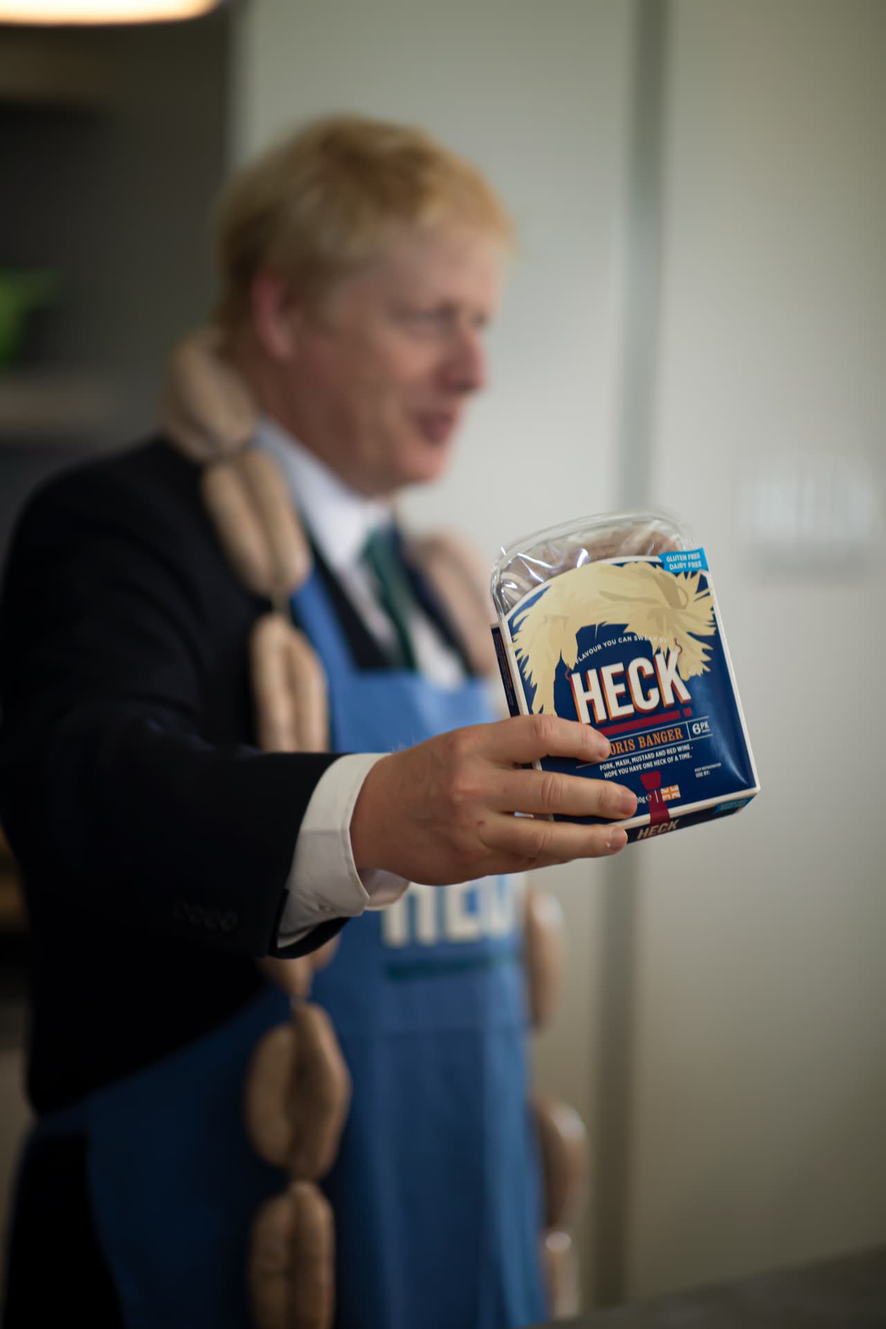 Boris Johnson holding a HECK Boris Banger pack